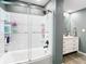 Tiled tub and shower combo in a modern bathroom with sleek gray walls at 2928 W Arch St, Tampa, FL 33607