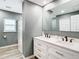 Modern bathroom with double vanity, spacious shower, and sleek gray walls at 2928 W Arch St, Tampa, FL 33607