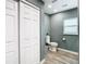 Gray bathroom with a toilet, and a closet with paneled doors at 2928 W Arch St, Tampa, FL 33607