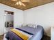 This bedroom features a ceiling fan, wood-look floors and a view to another room at 2928 W Arch St, Tampa, FL 33607
