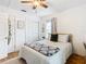 Bedroom with a ceiling fan and warm hardwood floors and natural light at 2928 W Arch St, Tampa, FL 33607