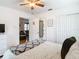 Bright bedroom with a ceiling fan and a view into the living room at 2928 W Arch St, Tampa, FL 33607