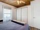 This bedroom features a ceiling fan, wood-look floors and a double closet at 2928 W Arch St, Tampa, FL 33607