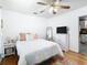 Sun-filled bedroom with wood floors, ceiling fan, and stylish decor at 2928 W Arch St, Tampa, FL 33607
