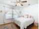 This bedroom features a ceiling fan, wood floors and a bright window at 2928 W Arch St, Tampa, FL 33607