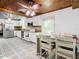 Modern kitchen featuring stainless steel appliances, white cabinetry, and cozy dining area at 2928 W Arch St, Tampa, FL 33607