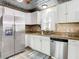 Well-equipped kitchen boasts granite countertops and stainless steel refrigerator at 2928 W Arch St, Tampa, FL 33607