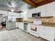 Charming kitchen featuring white appliances, granite countertops, and unique ceilings at 2928 W Arch St, Tampa, FL 33607