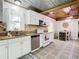 Bright kitchen featuring white cabinets, stainless steel appliances, and eat-in area at 2928 W Arch St, Tampa, FL 33607