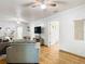 Bright living room features wood floors, ceiling fans, neutral walls, and comfortable gray couches, creating a welcoming space at 2928 W Arch St, Tampa, FL 33607