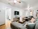 Open-concept living room with hardwood floors, entertainment center, and neutral decor at 2928 W Arch St, Tampa, FL 33607