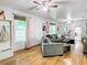 Bright living room features wood floors, ceiling fans, neutral walls, and comfortable gray couches, creating a welcoming space at 2928 W Arch St, Tampa, FL 33607