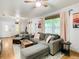 Comfortable living room with gray sectional sofa, ceiling fans, and natural light at 2928 W Arch St, Tampa, FL 33607