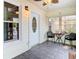 Inviting front porch with neutral paint, tiled floor, ceiling fan, front door with decorative glass, and outdoor furniture at 2928 W Arch St, Tampa, FL 33607