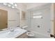 Well-lit bathroom features a tub and shower combination and a vanity with ample storage space at 2956 Sutherland Ct, Palm Harbor, FL 34684