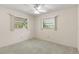 Bright bedroom with two windows, neutral walls, and carpet flooring awaiting personalization and decor at 2956 Sutherland Ct, Palm Harbor, FL 34684