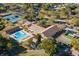 Aerial view of community center featuring a pool, tennis courts and recreation areas in a beautiful setting at 2956 Sutherland Ct, Palm Harbor, FL 34684