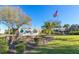Signage for Highland Lakes community amidst lush landscaping and a clear blue sky, creating inviting entrance at 2956 Sutherland Ct, Palm Harbor, FL 34684