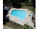 Aerial shot of the large community pool surrounded by ample lounge chairs and greenery at 2956 Sutherland Ct, Palm Harbor, FL 34684