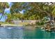 Scenic view of Highland Lakes community entrance, featuring a waterfall, lake, and lush landscaping at 2956 Sutherland Ct, Palm Harbor, FL 34684