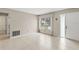 Open living space with tile flooring, a large window, and a neutral color palette for a clean, modern feel at 2956 Sutherland Ct, Palm Harbor, FL 34684