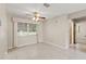 Bright living room with tile floors, ceiling fan, and access to other rooms, providing a functional layout at 2956 Sutherland Ct, Palm Harbor, FL 34684