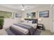 Comfortable bedroom features a ceiling fan, bedside tables, and modern decor for a relaxing ambiance at 2956 Sutherland Ct, Palm Harbor, FL 34684