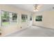 Sun room with carpeted floors and ample natural light from windows with view to the yard at 2956 Sutherland Ct, Palm Harbor, FL 34684