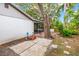 The backyard features a quaint patio, mature trees, and a lush garden, creating a peaceful outdoor retreat at 2986 Cypress Green Dr, Palm Harbor, FL 34684