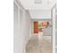 Inviting hallway features neutral walls, tile flooring, and a view into the open kitchen at 2986 Cypress Green Dr, Palm Harbor, FL 34684