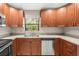 Updated kitchen with stainless steel dishwasher, stainless steel oven, and wooden cabinetry at 2986 Cypress Green Dr, Palm Harbor, FL 34684