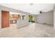 Open-concept living room with tile floors, ceiling fan, and sliding door to screened patio at 2986 Cypress Green Dr, Palm Harbor, FL 34684