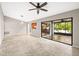 Open-concept living room with breakfast bar, ceiling fan, and access to the screened patio at 2986 Cypress Green Dr, Palm Harbor, FL 34684