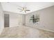Main bedroom with a ceiling fan, large window with blinds, and en-suite bathroom at 2986 Cypress Green Dr, Palm Harbor, FL 34684