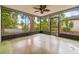Enclosed back porch with screened-in windows offers indoor-outdoor living and views of the serene backyard at 2986 Cypress Green Dr, Palm Harbor, FL 34684