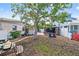 Landscaped backyard featuring a gazebo and mature trees, offering privacy and potential for outdoor activities at 301 14Th Ave, Indian Rocks Beach, FL 33785
