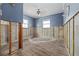 Bedroom featuring blue walls, new tile flooring, natural light, and walls prepped for remodeling at 301 14Th Ave, Indian Rocks Beach, FL 33785