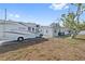 Exterior view of home with an RV parked nearby and a green yard at 301 14Th Ave, Indian Rocks Beach, FL 33785