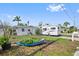 Exterior view of home with a large RV parked nearby and a grass yard at 301 14Th Ave, Indian Rocks Beach, FL 33785