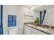 Modern bathroom boasts a double sink vanity with gray countertop and decorative blue towels at 3050 Pink Gerbera Sq, Plant City, FL 33566
