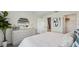 Well-lit bedroom featuring a modern dresser with decorative mirror and a white comforter at 3050 Pink Gerbera Sq, Plant City, FL 33566