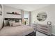Stylish bedroom with a dresser, accent mirror, and baseball cap decor on the wall at 3050 Pink Gerbera Sq, Plant City, FL 33566