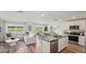 Bright open-concept living space featuring a modern kitchen, dining area, and comfortable lounge with water views at 3050 Pink Gerbera Sq, Plant City, FL 33566