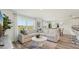 Spacious living room with an open floor plan, complemented by modern furnishings and abundant natural light at 3050 Pink Gerbera Sq, Plant City, FL 33566