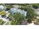 Aerial view of a well-maintained building with mature trees and ample parking at 3301 Haviland Ct # 203, Palm Harbor, FL 34684
