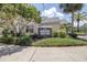 Charming community clubhouse with lush landscaping and a stone sign, offering a welcoming entrance for residents at 3301 Haviland Ct # 203, Palm Harbor, FL 34684
