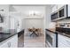 Open-concept featuring stainless steel appliances, granite countertops, breakfast nook and modern lighting at 3301 Haviland Ct # 203, Palm Harbor, FL 34684