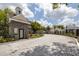 Stone entrance to the community with decorative landscaping and paved road at 3301 Haviland Ct # 203, Palm Harbor, FL 34684