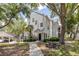 Charming two-story condo featuring a picnic table, lush landscaping, and covered parking at 3301 Haviland Ct # 203, Palm Harbor, FL 34684
