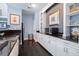 Modern kitchenette featuring granite countertops, white cabinetry, and stainless steel appliances at 3301 Haviland Ct # 203, Palm Harbor, FL 34684